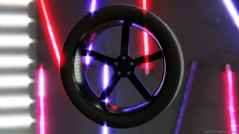 A black rim and tire in neon lights